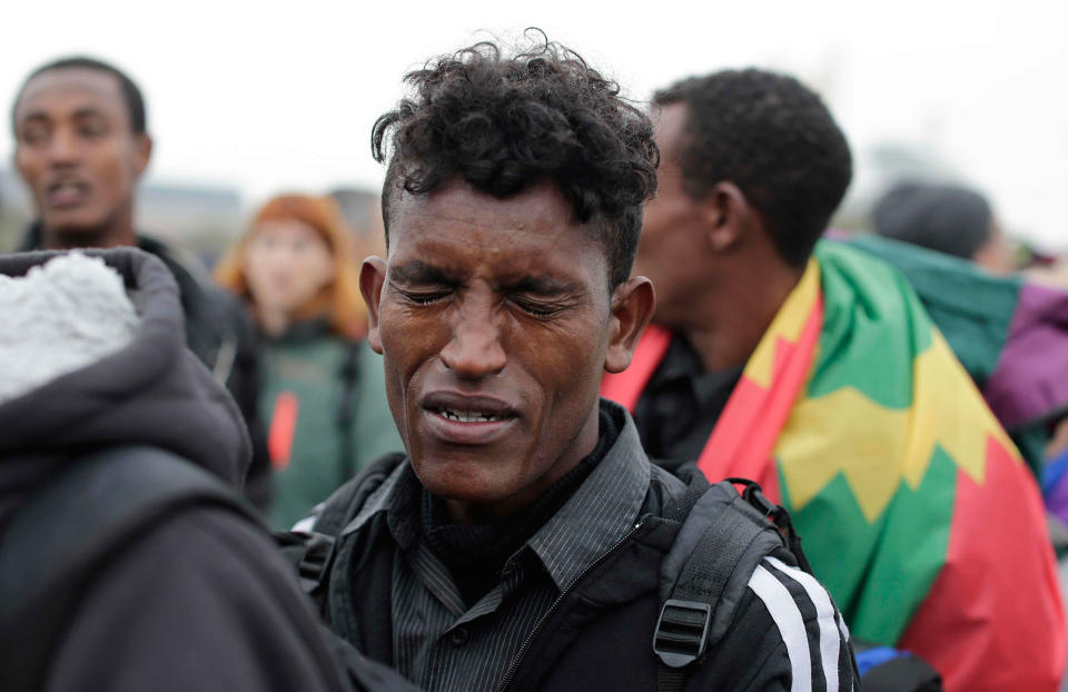 An Ethiopian migrant cries during evacuation of “the jungle,” in Calais, France