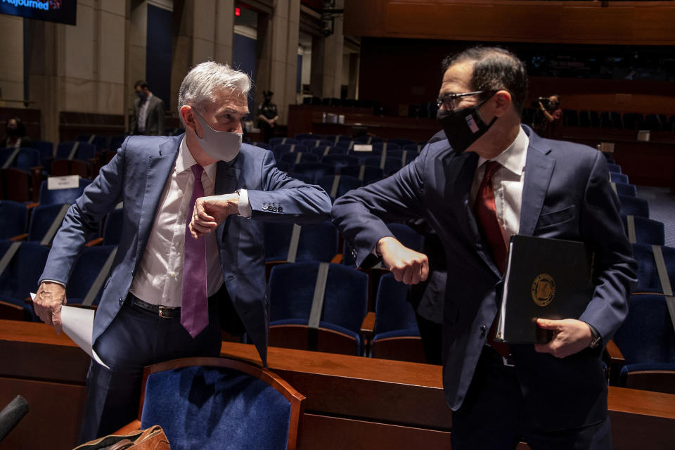 Federal Reserve Chairman Jerome Powell and U.S. Treasury Secretary Steven Mnuchin bump elbows after a hearing of the House of Representatives Financial Services Committee on oversight of the Treasury Department and Federal Reserve response to the outbreak of the coronavirus disease (COVID-19), on Capitol Hill in Washington, U.S., June 30, 2020. Tasos Katopodis/Pool via REUTERS     TPX IMAGES OF THE DAY