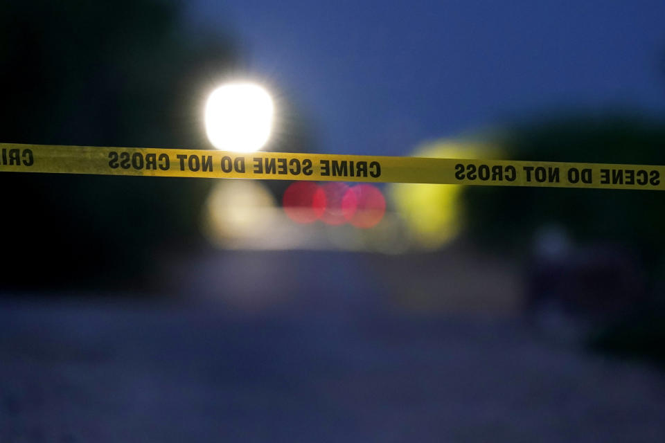 Police protect the scene where officials say dozens of people have been found dead and multiple others were taken to hospitals with heat-related illnesses after a semitrailer containing suspected migrants was found, Tuesday, June 28, 2022, in San Antonio. (AP Photo/Eric Gay)