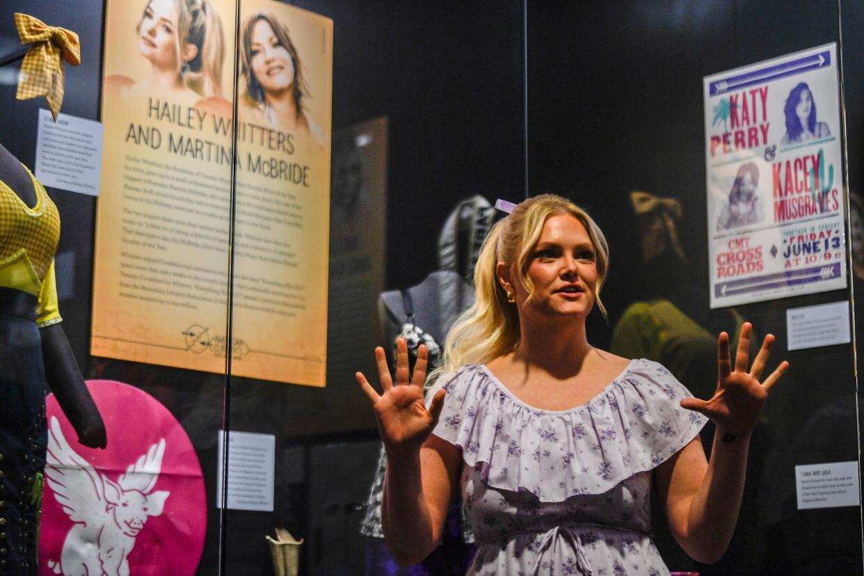 Hailey Whitters talks about the attire behind the glass in the American Currents Gallery at the Country Music Hall of Fame in Nashville, Tenn., Tuesday, Feb. 27, 2024.