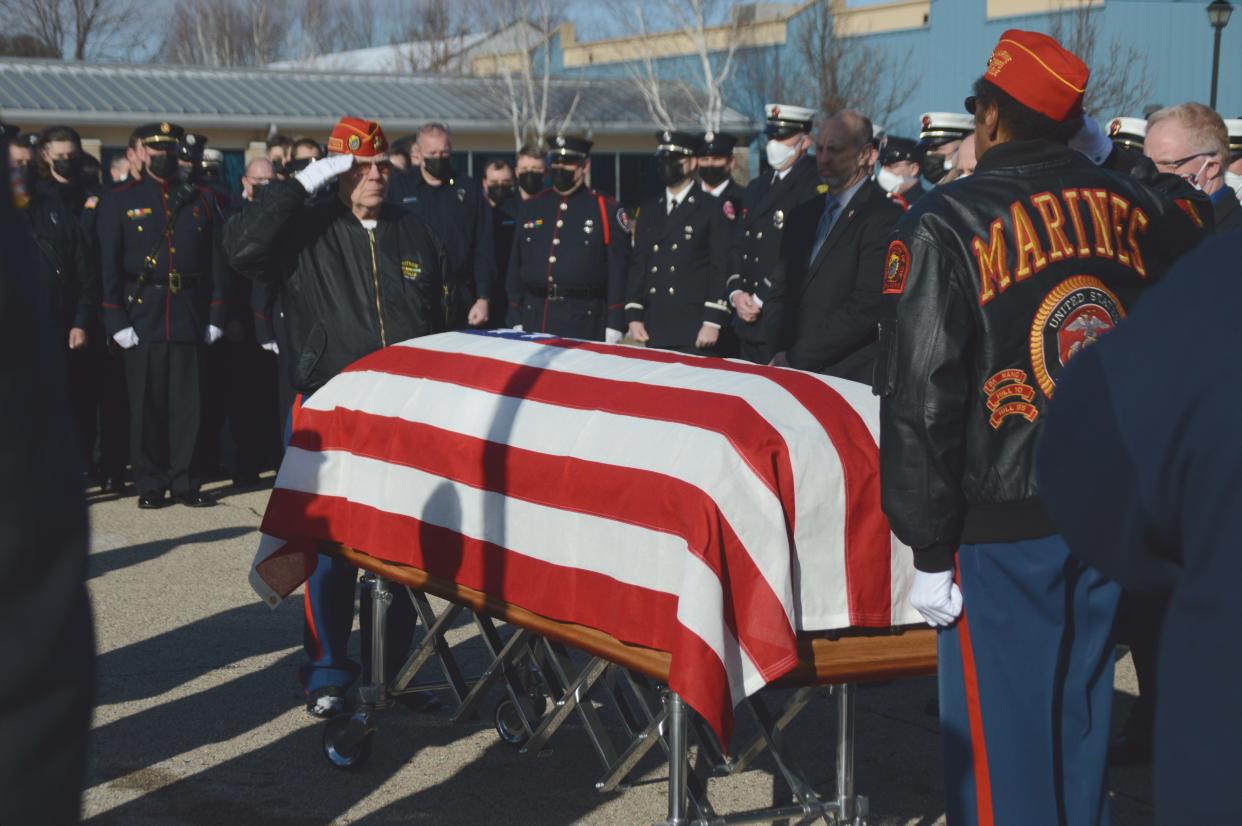 Members of the VFW Post 2306 Honor Guard salute the casket of Freeport Fire Chief Brad Liggett on Jan. 15, 2022, outside Central Christian Church in Beloit, Wisconsin.