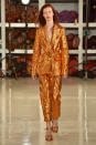 <p>Model wears an orange metallic pantsuit at the fall 2018 Sies Marjan show. (Photo: Getty Images) </p>