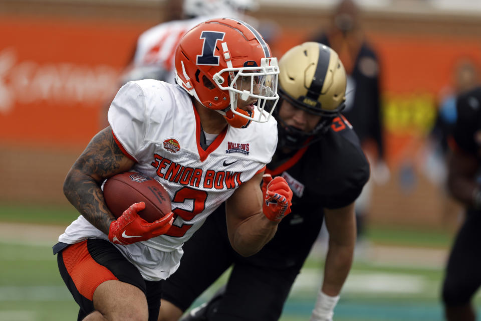 National running back Chase Brown of Illinois (2) carries the ball during practice for the Senior Bowl NCAA college football game Wednesday, Feb. 1, 2023, in Mobile, Ala.. (AP Photo/Butch Dill)