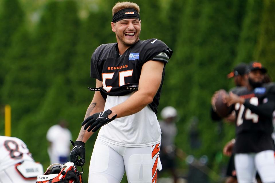 Cincinnati Bengals linebacker Logan Wilson (55) talks with teammates before stretch during Cincinnati Bengals training camp practice, Thursday, Aug. 4, 2022, at the Paul Brown Stadium practice fields in Cincinnati. 