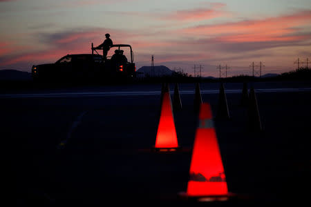 Traffic lit cones are seen at a checkpoint as military personnel patrol the perimeter of a high security prison where drug lord Joaquin "El Chapo" Guzman is imprisoned in Ciudad Juarez, Mexico May 11, 2016. REUTERS/Jose Luis Gonzalez