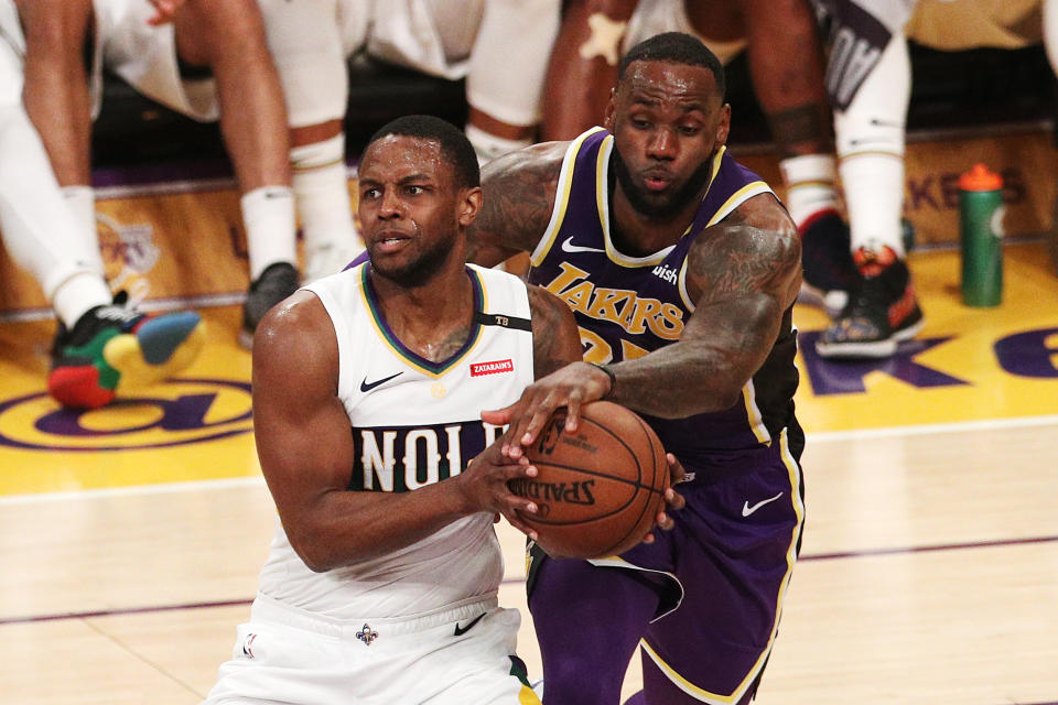 LeBron James swipes for the ball against Darius Miller of the Pelicans during the first half Wednesday in Los Angeles. (Getty Images)