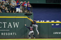 Cleveland Guardians left fielder Will Brennan (63) looks on as center fielder Myles Straw attempts to reach a solo home run ball hit by Texas Rangers' Marcus Semien in the third inning of a baseball game in Arlington, Texas, Saturday, Sept. 24, 2022. (AP Photo/Tony Gutierrez)