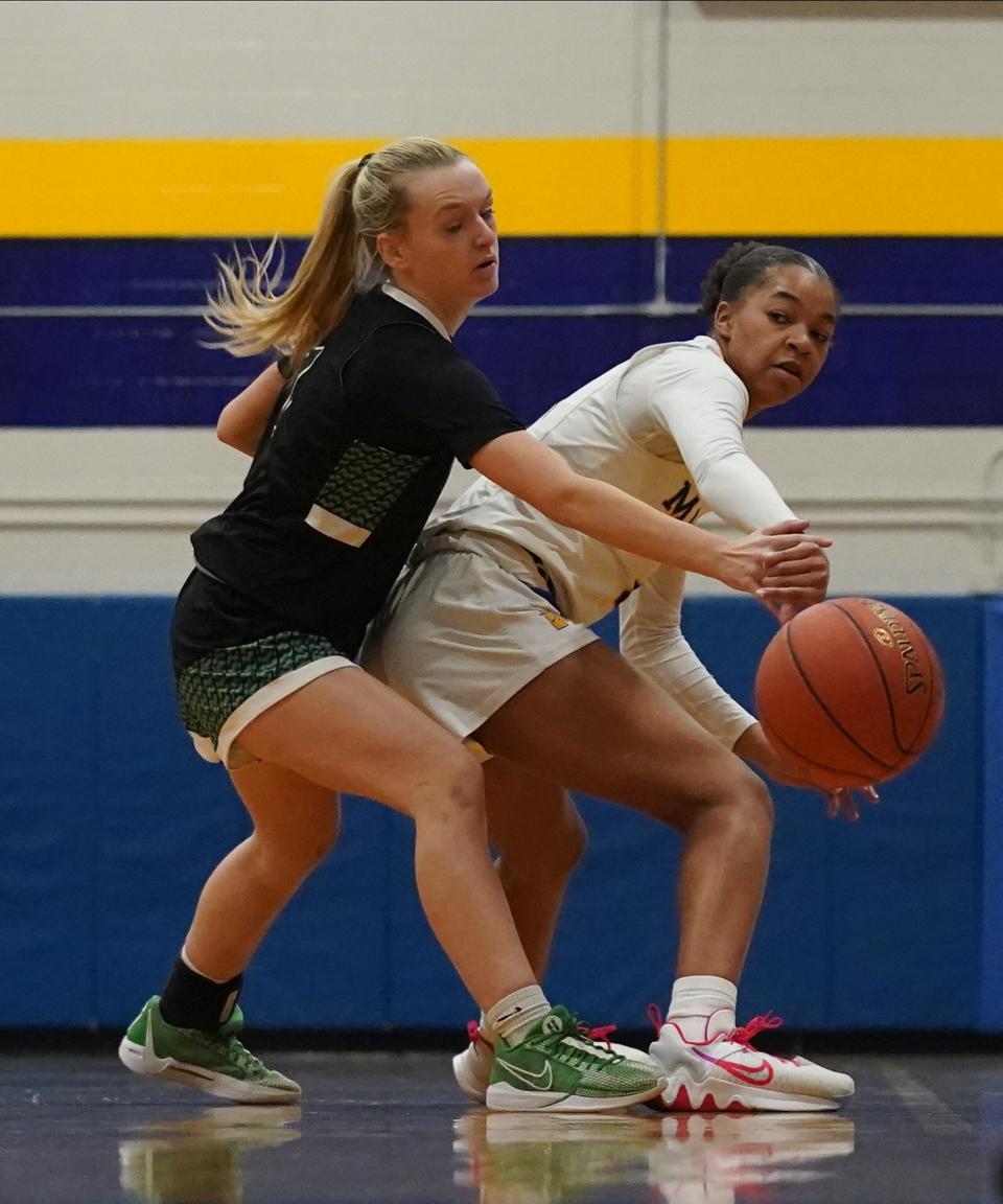 Mahopac's Madysen Ford (4) feeds a pass around Yorktown's Kaitlyn Judge (1) during their 49-28 win in the first round of the Class AA girls basketball playoffs at Mahopac High School on Friday, Feb. 16, 2024.