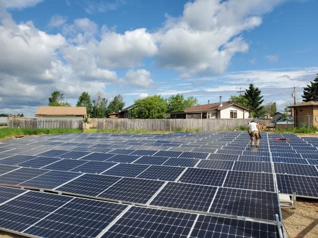 The community of Ile-a-la-Crosse has now branched into solar power and had their senior class at the high school put the panels together to learn about the infrastructure.  (Submitted by David Isaac  - image credit)