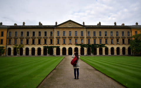 A woman photographs part of Magdalen College  - Credit: Carl Court/Getty Images Europe 