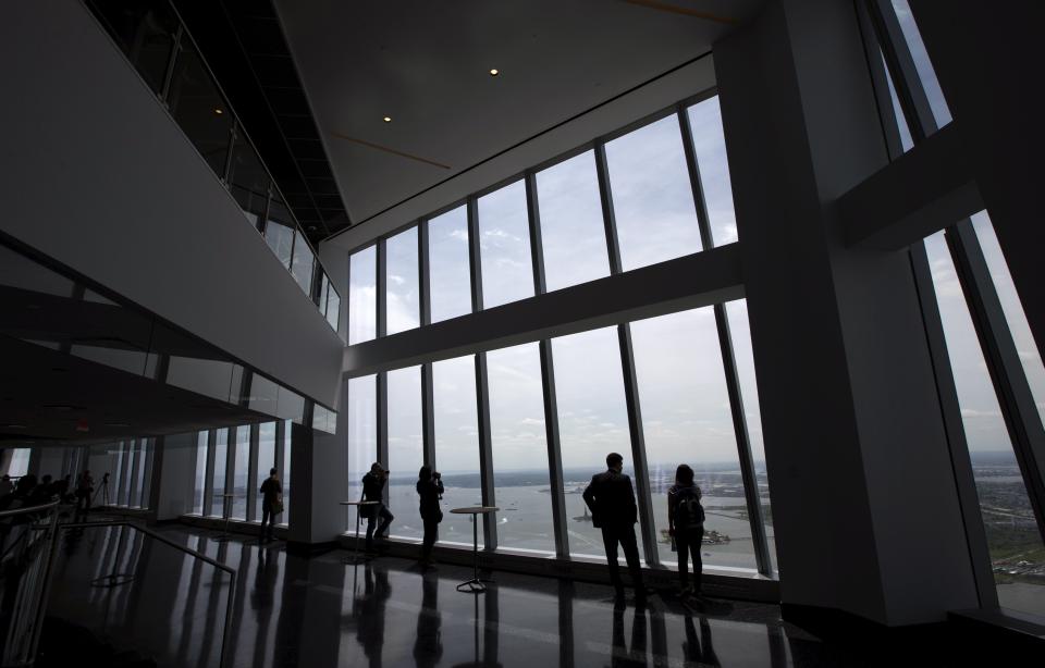 Members of the media stand at the windows at the One World Observatory observation deck on the 100th floor of the One World Trade (REUTERS/Mike Segar)