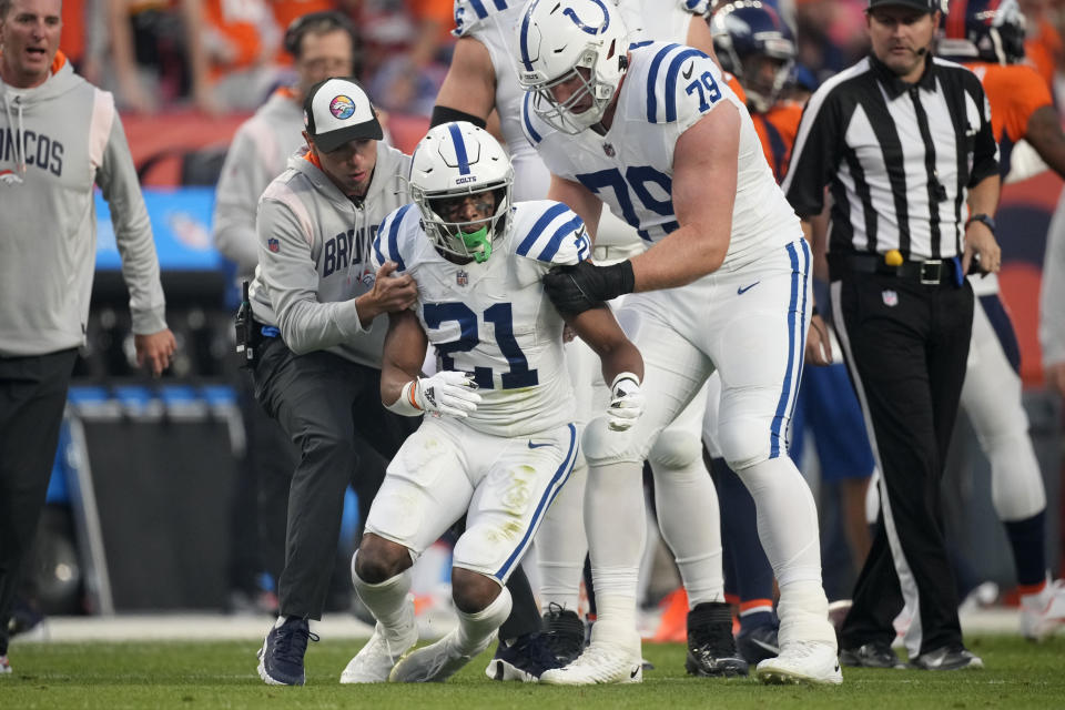 Indianapolis Colts running back Nyheim Hines (21) stumbles as he tries to get up after being injured against the Denver Broncos during the first half of an NFL football game, Thursday, Oct. 6, 2022, in Denver. (AP Photo/David Zalubowski)