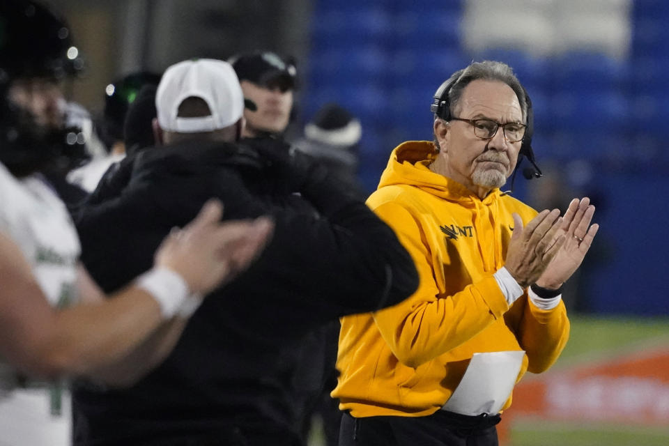 North Texas head coach Phil Bennett claps on the sideline during the first half of the Frisco Bowl NCAA college football game against Boise State, Saturday, Dec. 17, 2022, in Frisco, Texas. (AP Photo/LM Otero)