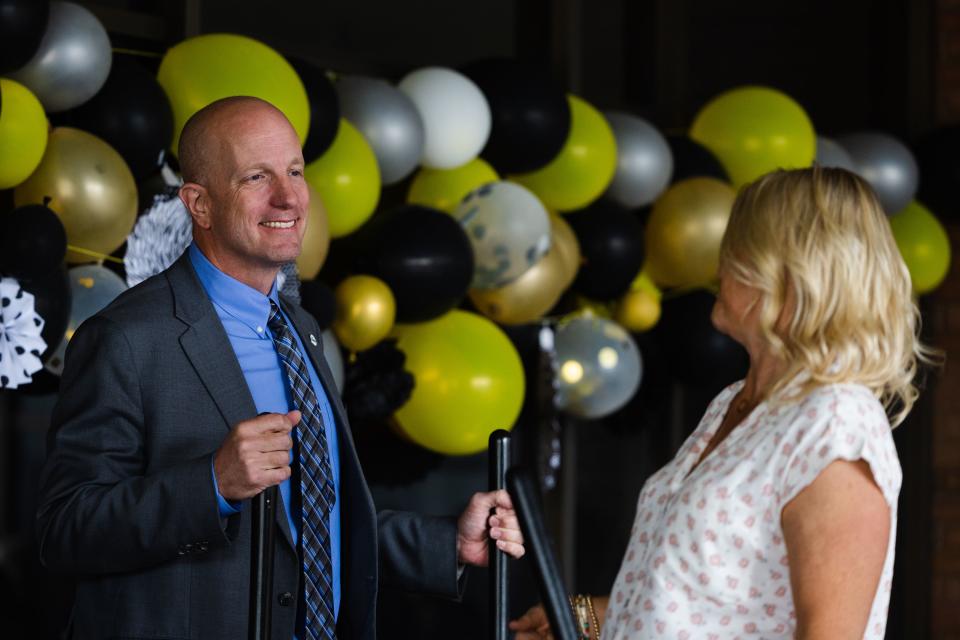 Granitei School District Superintendent Rich Nye, left, speaks with Robyn Ivins, right, during a groundbreaking event for a teen resource center at Cottonwood High School in Murray on Thursday, June 1, 2023. | Ryan Sun, Deseret News
