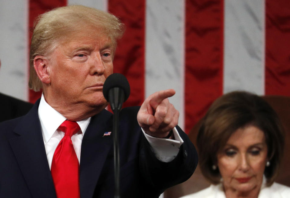 President Donald Trump delivers his State of the Union address to a joint session of Congress in the House Chamber on Capitol Hill in Washington, Tuesday, Feb. 4, 2020, as Nancy Pelosi listens. (Leah Millis/Pool via AP)