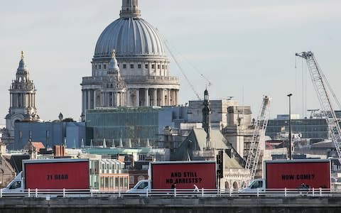 The Community-led organisation, Justice4Grenfell, parades three billboards backdropped by St. Paul's Cathedral - Credit: AP