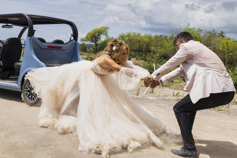 This image released by Lionsgate shows Jennifer Lopez, left, and Josh Duhamel in a scene from "Shotgun Wedding." (Ana Carballosa/Lionsgate via AP)