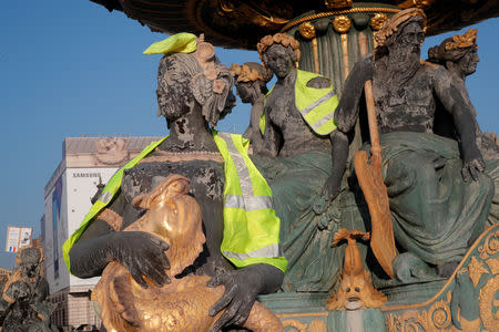 Yellow vests, a symbol of a French drivers' protest against higher fuel prices, are seen on statues on a fountain on the Place de la Concorde in Paris, France, November 17, 2018. REUTERS/Charles Platiau