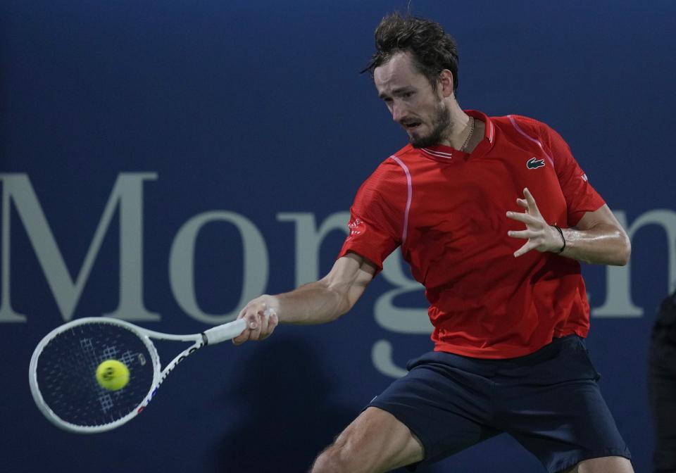 Daniil Medvedev returns the ball to Serbia's Novak Djokovic during their semi final match of the Dubai Duty Free Tennis Championships in Dubai, United Arab Emirates, Friday, March 2, 2023. (AP Photo/Kamran Jebreili)