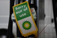 Out of use signs are placed over pumps at a Shell petrol station in London