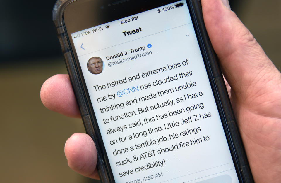 SANTA FE, NEW MEXICO - AUGUST 30, 2018:  A man uses his smartphone to read a tweet from U.S. President Donald Trump attacking CNN and the television network's president, Jeff Zucker, for alleged media bias.  (Photo by Robert Alexander/Getty Images)