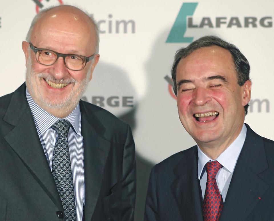 Bruno Lafont, right, chairman and chief executive of French cement maker Lafarge Group shares a laugh with Swiss cement maker Holcim chairman Rolf Soiron before a press conference, Monday, April 7, 2014 in Paris. Lafont and Soiron announced plans for a "merger of equals" Monday that would create an industry giant with a combined euro32 billion US$43.9 billion in annual revenues. (AP Photo/Jacques Brinon)