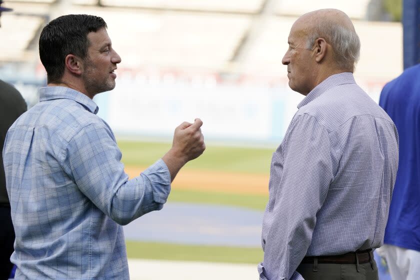 Dodgers President of Baseball Operations Andrew Friedman speaks with co-owner Stan Kasten.