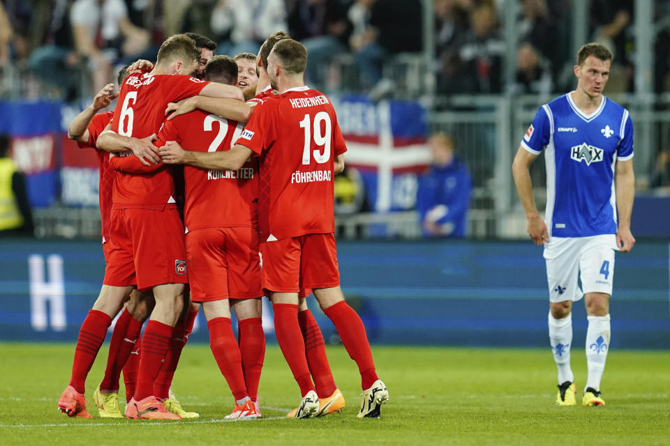 Heidenheim team celebrate a goal during the Bundesliga soccer match between SV Darmstadt 98 and 1. FC Heidenheim in Darmstadt, Germany, Sunday April 28, 2024. (Uwe Anspach/dpa via AP)