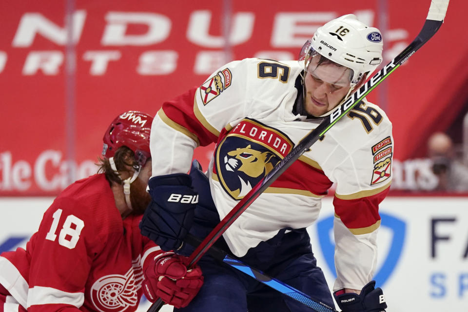 Detroit Red Wings defenseman Marc Staal (18) high-sticks Florida Panthers center Aleksander Barkov (16) during the first period of an NHL hockey game, Saturday, Jan. 30, 2021, in Detroit. (AP Photo/Carlos Osorio)