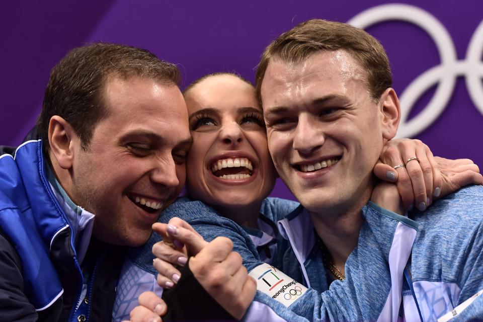 <p>Israel’s Paige Conners (C) and Israel’s Evgeni Krasnopolski react after competing in the pair skating short program of the figure skating event during the Pyeongchang 2018 Winter Olympic Games at the Gangneung Ice Arena in Gangneung on February 14, 2018. / AFP PHOTO / ARIS MESSINIS </p>