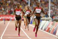 Purity Cherotich Kirui of Kenya (R) crosses the line ahead of her compatriot Milcah Chemos Cheywa to win the women's 3000 metres steeplechase final at the 2014 Commonwealth Games in Glasgow, Scotland, July 30, 2014. REUTERS/Phil Noble