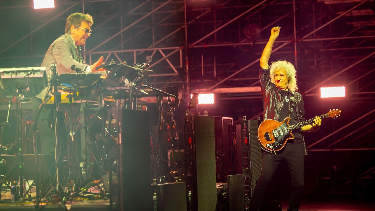 Jean-Michel Jarre on the left, and Brian May with his signature red guitar on the right, performing on stage. 