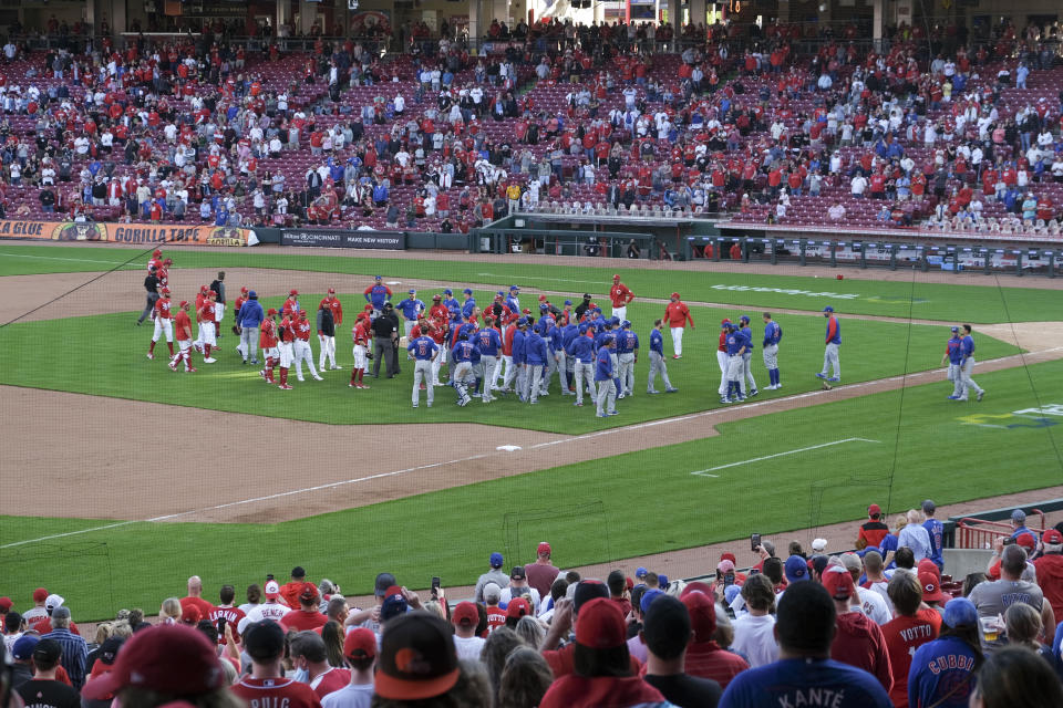 Players from both teams come onto the field in the eighth inning during a baseball game between the Chicago Cubs and the Cincinnati Reds in Cincinnati on Saturday, May 1, 2021. (AP Photo/Jeff Dean)