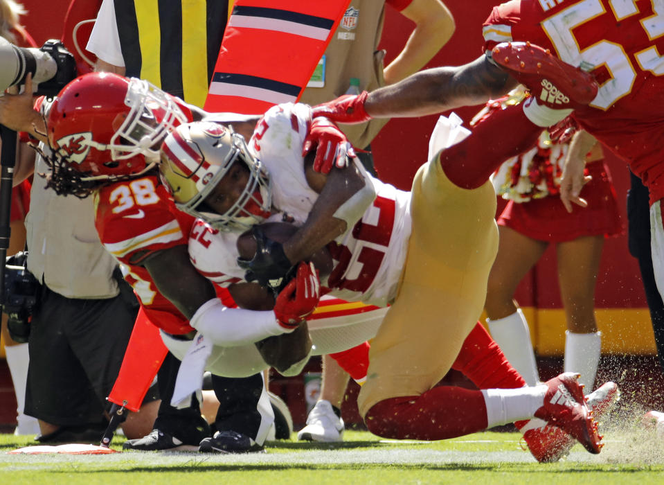 Kansas City Chiefs defensive back Ron Parker (38) tackles San Francisco 49ers running back Matt Breida (22) during the first half of an NFL football game in Kansas City, Mo., Sunday, Sept. 23, 2018. (AP Photo/Charlie Riedel)