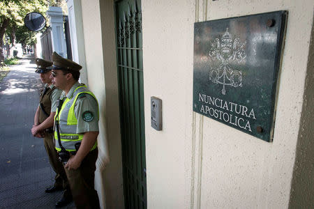 Police stand guard at the apostolic nunciature, where the Vatican special envoy Archbishop Charles Scicluna meets with victims of sexual abuse, allegedly committed by members of the church, in Santiago, Chile. February 21, 2018. . REUTERS/Claudio Santana