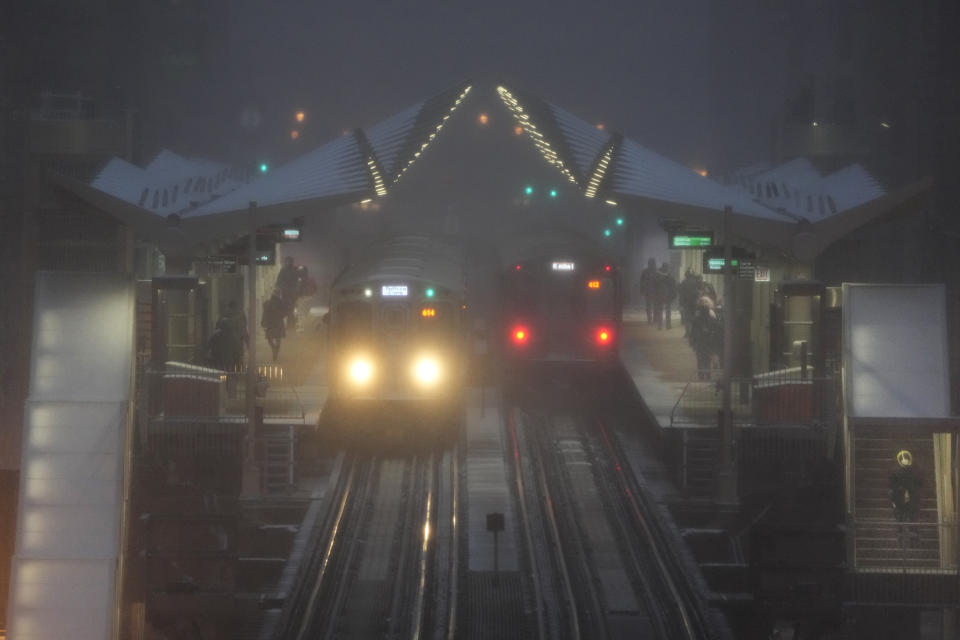 Two Chicago Transit Authority trains sit in an elevated station in Chicago's famed Loop as a winter storm continues Thursday, Dec. 22, 2022. A massive winter storm will be hovering over the majority of the country for a few days featuring strong wind chills and major snow accumalation. (AP Photo/Charles Rex Arbogast)