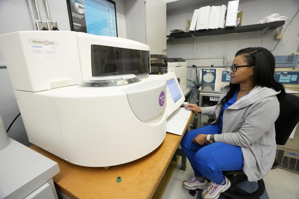 Britney Johnson, the laboratory manager at the Alliance Healthcare System hospital in Holly Springs, Miss., runs tests, Feb. 29, 2024. The medical facility was initially approved by the federal government as a rural emergency hospital in March, 2023, requiring closing all inpatient beds and providing 24/7 emergency care. However, they have been denied the status and must now transition back to a full-service hospital. (AP Photo/Rogelio V. Solis)