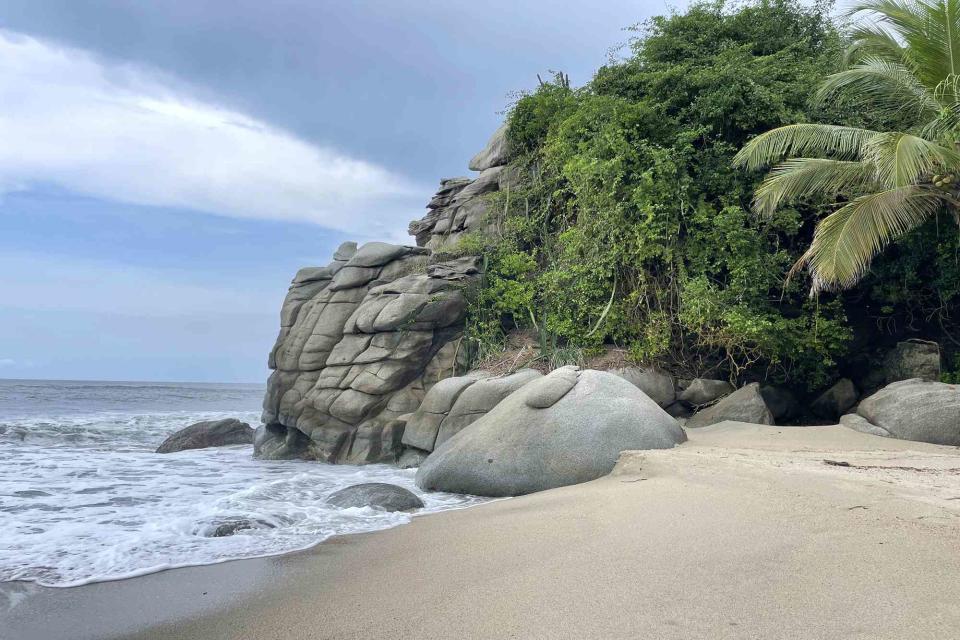 <p>National Geographic Expeditions</p> Surrounded by both mountains and sea, travelers on the Colombia Signature Land itinerary with National Geographic Expeditions will explore Tayrona National Park as an expert naturalist teaches them about the surrounding environment.