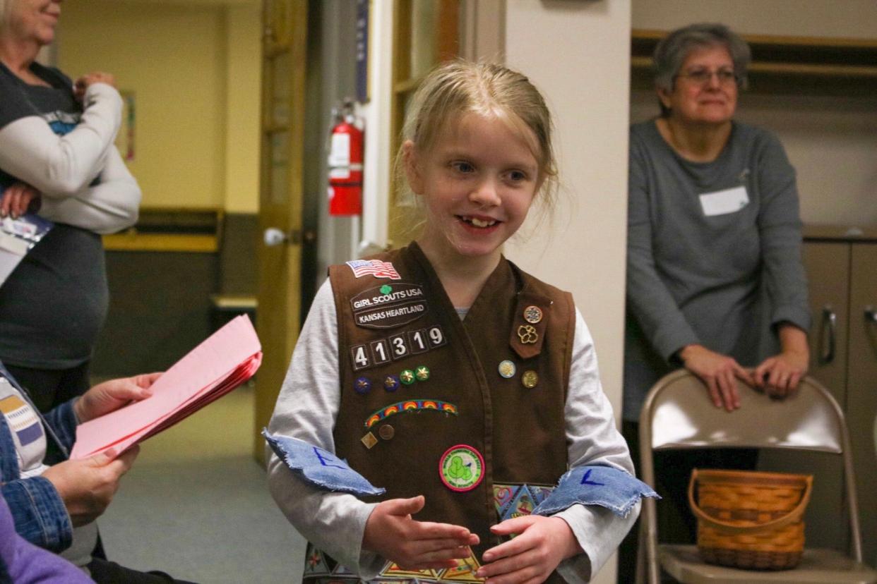 Madeline Bowen, 9, balances bean bags labeled "L" and "E" for executive and legislative branches of government. Bowen is one of around 35 Girl Scouts who earned their Democracy Badge at the workshop Saturday.