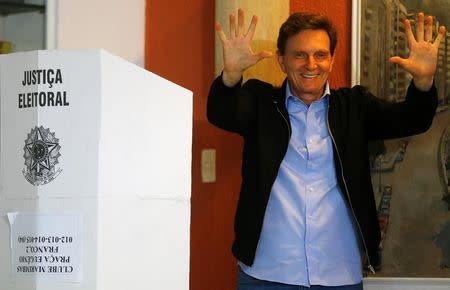 Senator Marcelo Crivella, candidate for Rio de Janeiro mayor, gestures to photographers after voting during the municipal elections at a polling station in Rio de Janeiro, Brazil, October 30, 2016. REUTERS/Ricardo Moraes