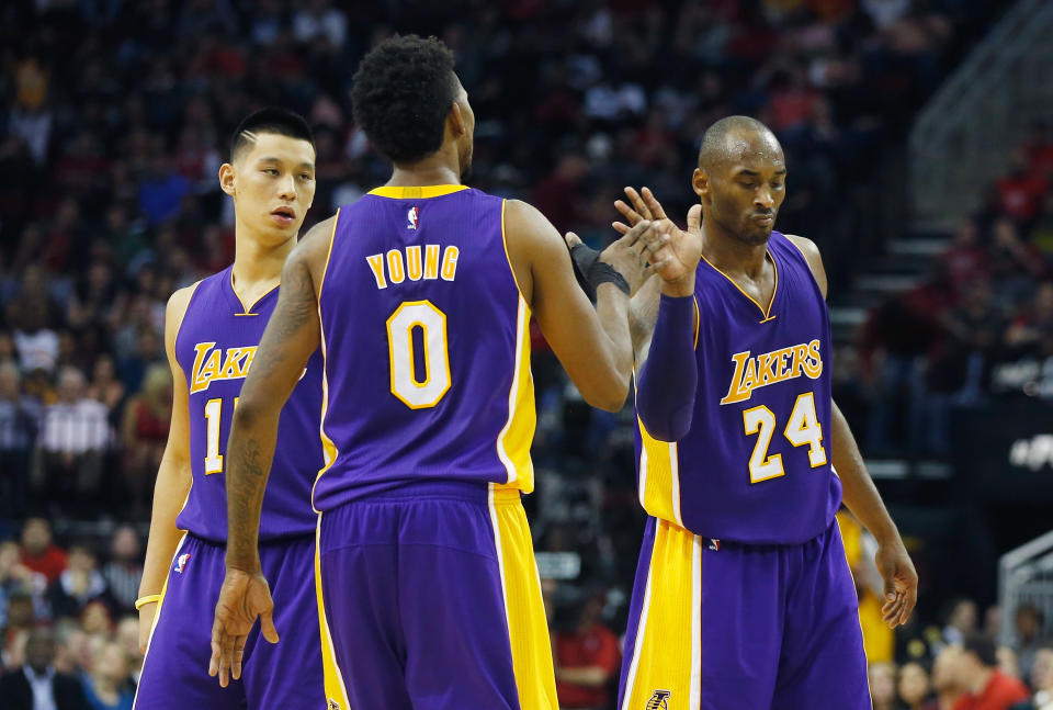 HOUSTON, TX - NOVEMBER 19: Kobe Bryant #24 of the Los Angeles Lakers celebrates a play with Jeremy Lin #17 and Nick Young #0 during their game against the Houston Rockets at the Toyota Center on November 19, 2014 in Houston, Texas. NOTE TO USER: User expressly acknowledges and agrees that, by downloading and/or using this photograph, user is consenting to the terms and conditions of the Getty Images License Agreement. 