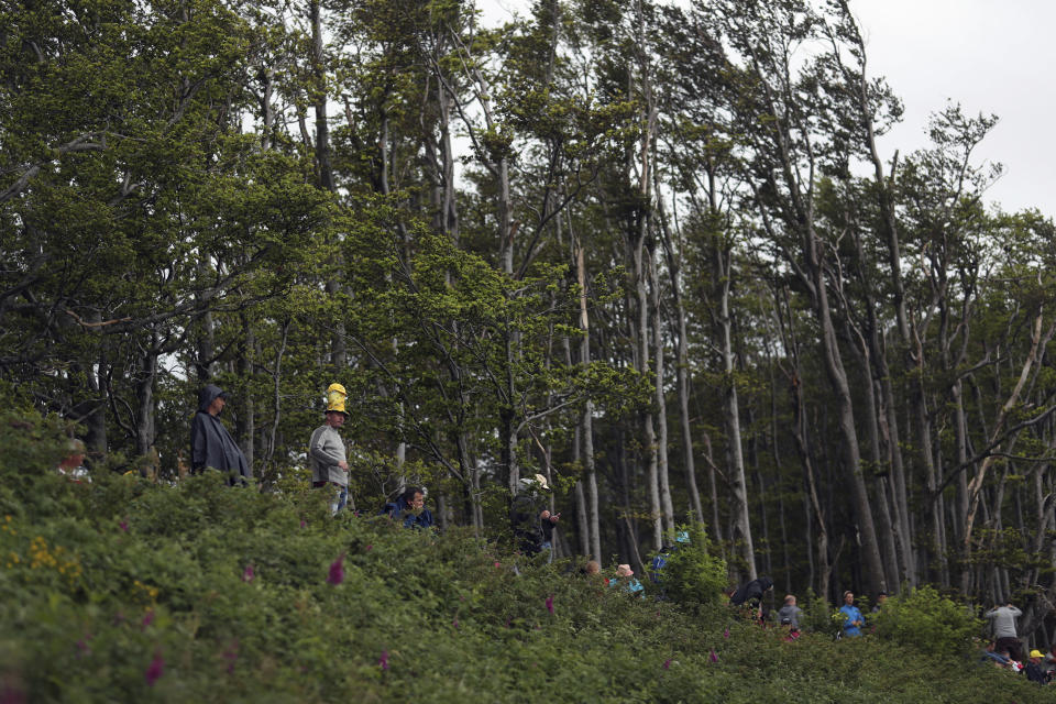 Spectators stand next to the finish line of the sixth stage of the Tour de France cycling race over 160 kilometers (100 miles) with start in Mulhouse and finish in La Planche des Belles Filles, France, Thursday, July 11, 2019. (AP Photo/Thibault Camus)