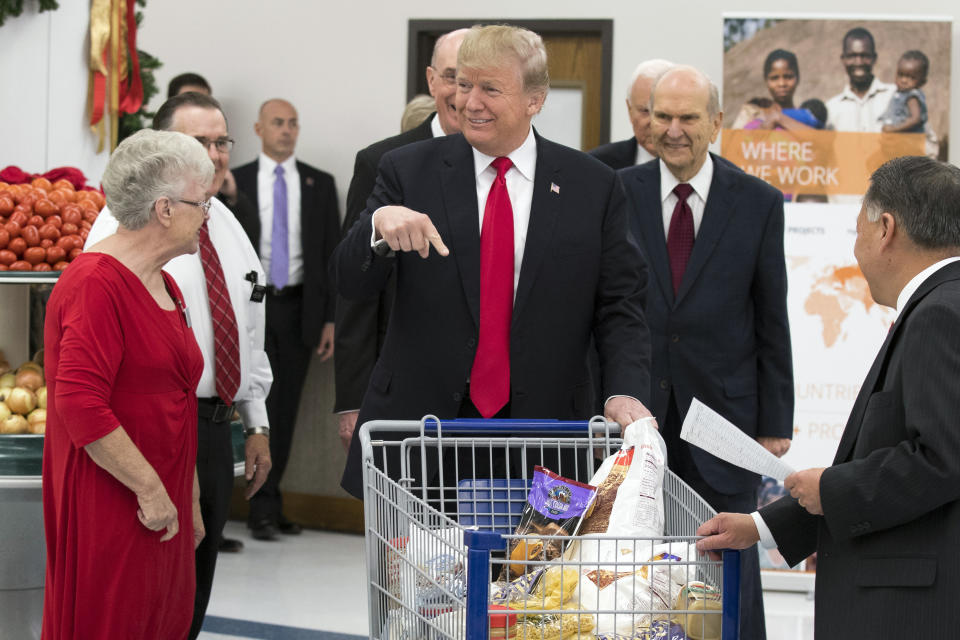 President Donald Trump points to his shopping cart during a tour of the Church of Jesus Christ of Latter-Day Saints Welfare Square food distribution center in December 2017 in Salt Lake City. (Photo: THE ASSOCIATED PRESS)