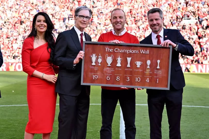 Ray Houghan posing for a photograph with Linda and John Henry owner of Liverpool and CEO of Liverpool Billy Hogan at the end of the Premier League match between Liverpool FC and Wolverhampton Wanderers at Anfield on May 19, 2024 in Liverpool, England.