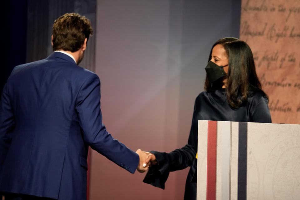 Former U.S. Rep. Joe Cunningham, left, shakes hands with state Sen. Mia McLeod ahead of a debate among Democratic gubernatorial candidates on Friday, June 10, 2022, in Columbia, S.C. (AP Photo/Meg Kinnard)