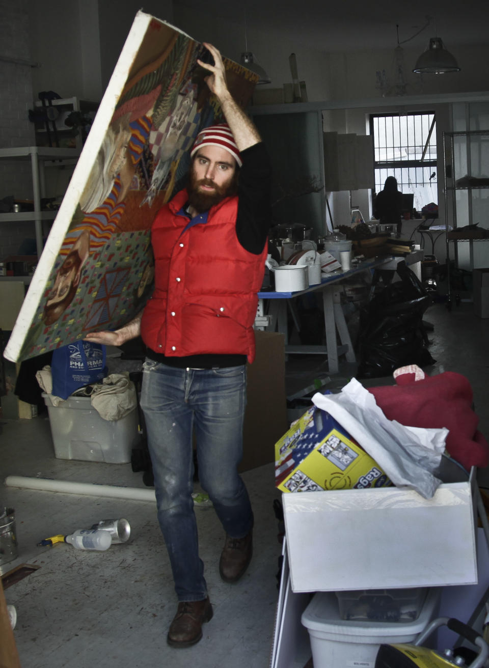 John Gordon Gauld, an artist who lost paintings during superstorm Sandy, moves a painting out of his Red Hook studio on Monday, Dec. 3, 2012 in New York. (AP Photo/Bebeto Matthews)