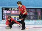 Britain's skip Eve Muirhead (L) delivers a stone as Britain's second Vicki Adams prepares to sweep in their women's bronze medal curling game against Switzerland at the Ice Cube Curling Centre during the Sochi 2014 Winter Olympics February 20, 2014. REUTERS/Ints Kalnins