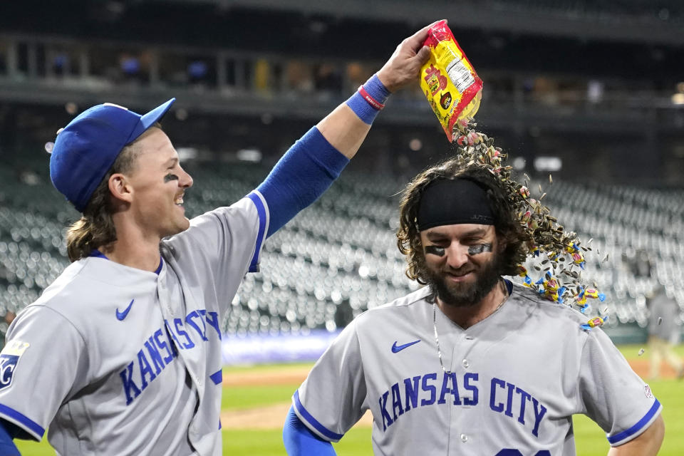 Kansas City Royals' Bobby Witt Jr., left, dumps sunflower seeds, bubble gum and candy onto catcher Logan Porter after the team's 11-10 win over the Chicago White Sox in the second game of a baseball doubleheader Tuesday, Sept. 12, 2023, in Chicago. (AP Photo/Charles Rex Arbogast)