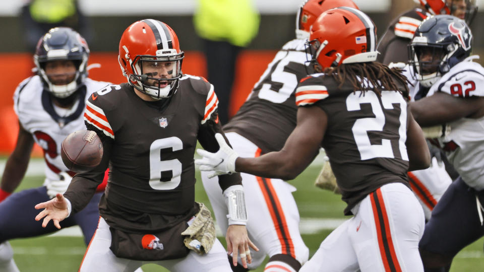 Cleveland Browns quarterback Baker Mayfield (6) tosses the ball to running back Kareem Hunt (27) during the first half of an NFL football game against the Houston Texans, Sunday, Nov. 15, 2020, in Cleveland. (AP Photo/Ron Schwane)