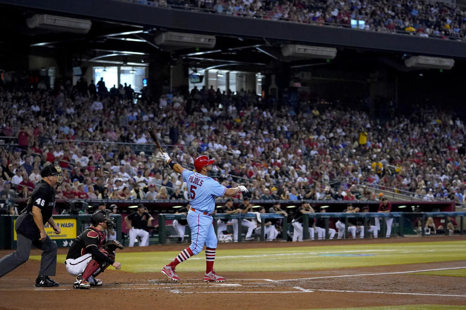 St. Louis Cardinals' Albert Pujols watches his solo home run take flight against the Arizona Diamondbacks during the second inning of a baseball game, Saturday, Aug. 20, 2022, in Phoenix. (AP Photo/Matt York)